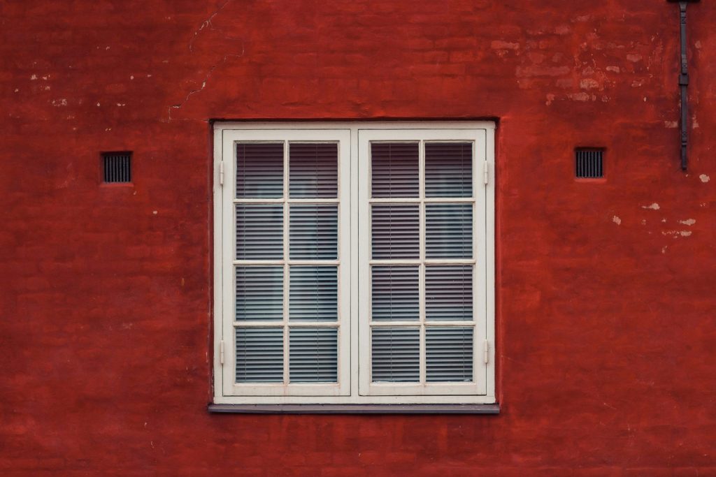 A red brick building with a white window